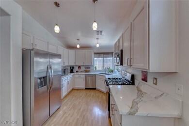 Kitchen featuring stainless steel appliances, vaul