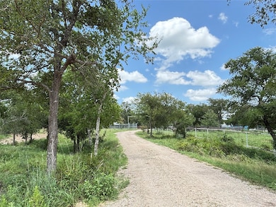 View of dirt / gravel road with a view of rural / pastoral area