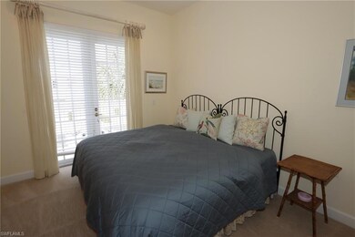 Carpeted bedroom with baseboards and access to ext