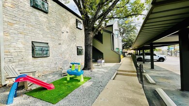 View of side of property featuring stone siding