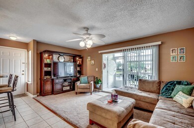 Tiled living room with a textured ceiling and ceil