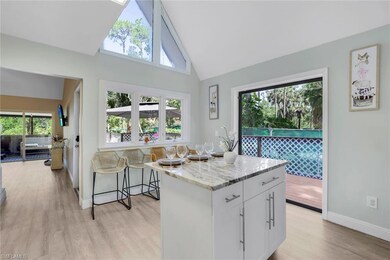Kitchen featuring white cabinetry, a kitchen islan