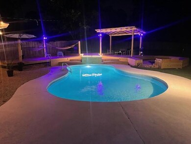 Pool at twilight featuring a fenced in pool, smart