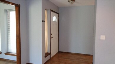 Laminate flooring entry. Door way to the left is dining room to the right is to bedrooms.