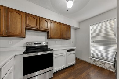 Kitchen with laminate flooring and electric range