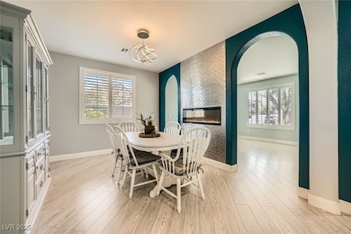 Dining space featuring arched walkways, a multi si