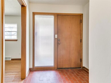 Foyer with dark hardwood / wood-style flooring