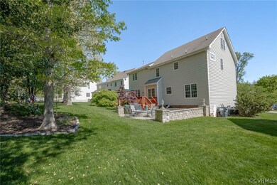 Lush Mature Landscaping, Lovely Lawn, Paver Stone Patio, Sitting Walls, and Firepit along with a Large Rear Deck for relaxing and enjoying nature!