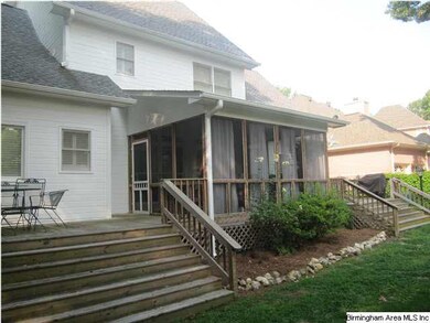 Back view with 2 decks, screened porch, and fenced