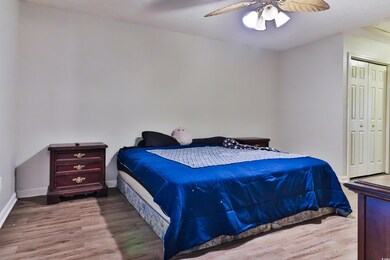 Bedroom with hardwood / wood-style flooring, a clo