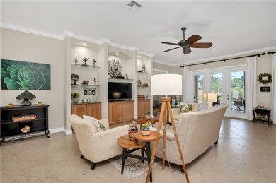 FAMILY ROOM WITH BUILT-INS AND FRENCH DOORS TO LAN