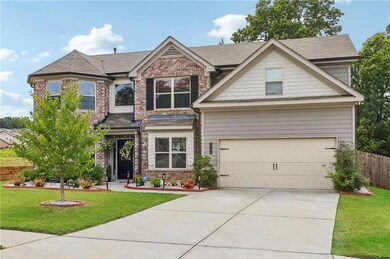 Craftsman-style home featuring a front lawn, brick