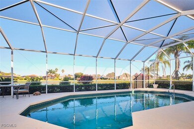 Swimming pool featuring glass enclosure and a sunroom