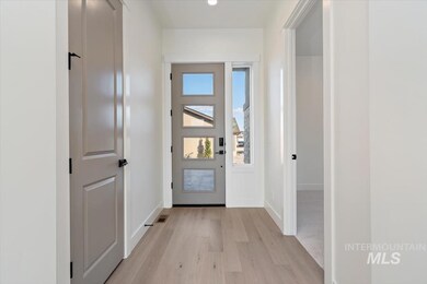Doorway to outside with wood finished floors and baseboards