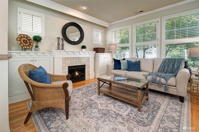 Living Room boasts gas fireplace flanked by built-in cabinetry.