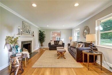 Large living room with fireplace and built-ins fac