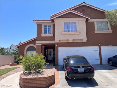 View of front of house with stucco siding, an atta