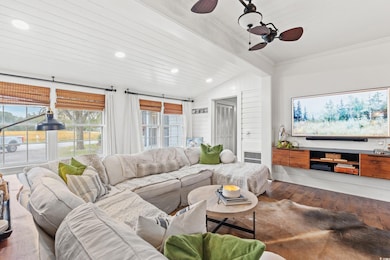 Living room featuring a ceiling fan, wood finished floors, vaulted ceiling, healthy amount of natural light, and recessed lighting