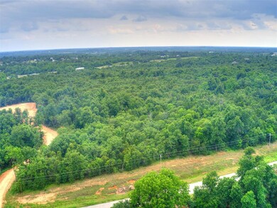 Aerial view featuring a view of trees