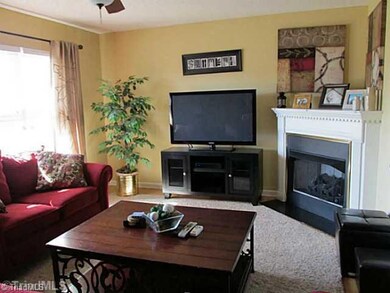 Living Room. Large windows fill the room with light.  Corner gas fireplace.