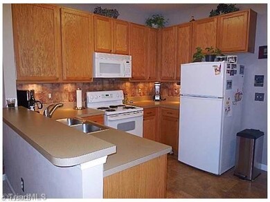 Kitchen. The kitchen offers ample counter space and taller cabinets for storage.  Tile flooring is a beautiful update in the kitchen area.