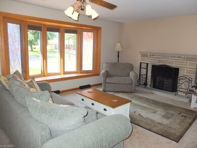 Living room with fireplace and bay window.