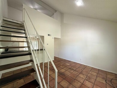 Staircase with lofted ceiling and baseboards