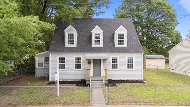 Cape cod home featuring a gate, a chimney, roof wi