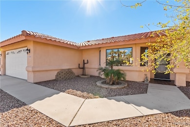 View of front of home featuring a tiled roof, an a
