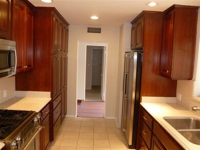 View from kitchen across entry hall to upstairs ba