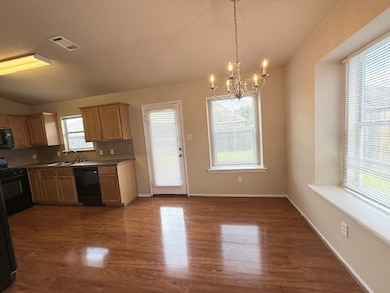 Kitchen featuring a chandelier, range, tasteful ba