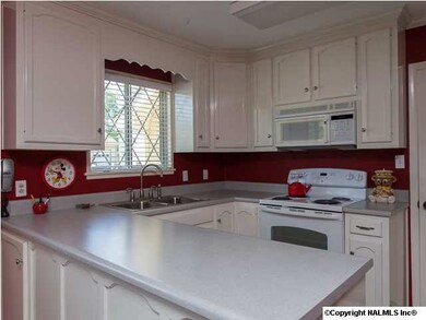 Step-saver kitchen is efficiently designed and fully equipped with stove, dishwasher & microwave.