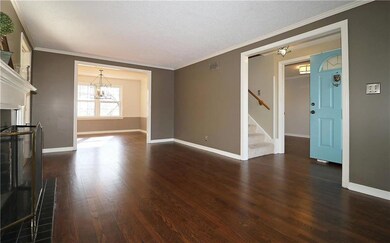 Spacious living room with fireplace and view into 