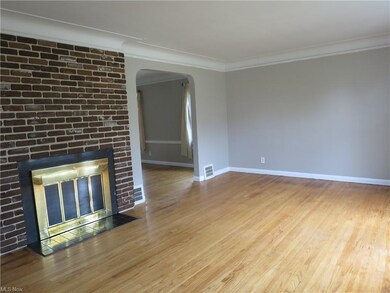 Gleaming hardwood floors and a wood burning firepl