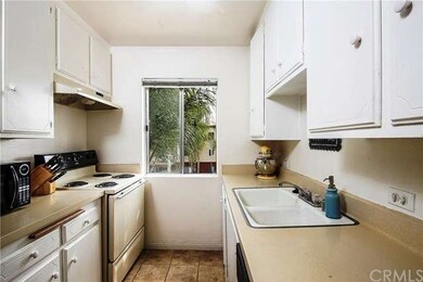 Kitchen with tile flooring, and lots of cabinets a