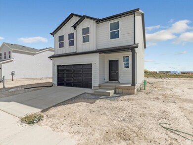Modern farmhouse style home with board and batten siding, an attached garage, and concrete driveway