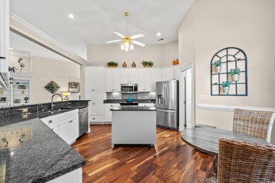 Kitchen featuring a sink, white cabinets, applianc