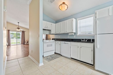 Kitchen featuring white appliances, light tile pat