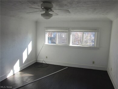 Unfurnished room with a textured ceiling, hardwood / wood-style flooring, and ceiling fan
