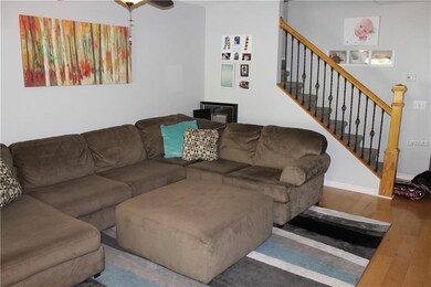 Living room shows wrought iron staircase
