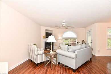 Living room is cozy and has plenty of windows for natural light.   The engineered floors are newer, and beautiful.