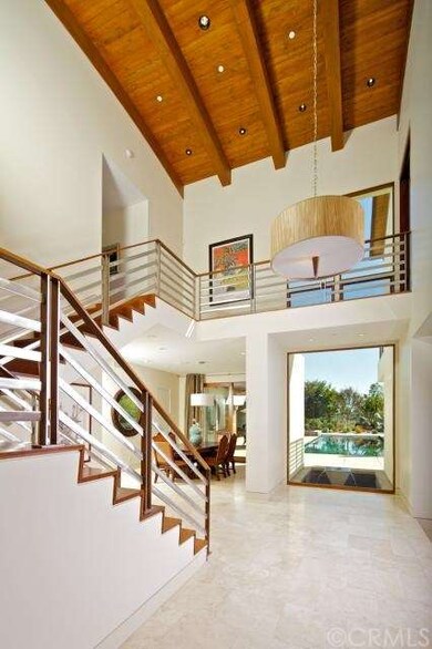 As you step into the spacious entryway, your eyes 