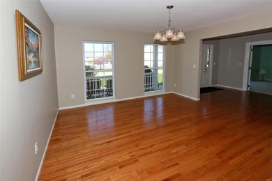 Dining room with hardwood floors, and new light fi