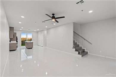 Unfurnished living room featuring light tile patterned flooring, baseboards, and visible vents