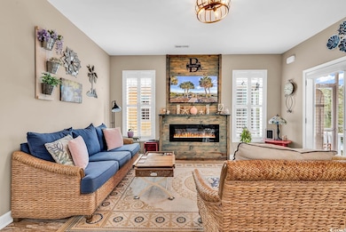 Living room with an inviting chandelier, a glass c