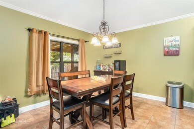 Tiled dining space with ornamental molding and a n