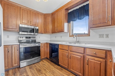 Clean kitchen with updated range & microwave, window above the sink, and lots of counter space.