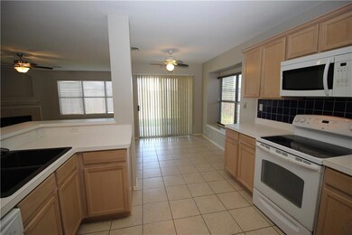 Kitchen features smooth top range, microwave, dish