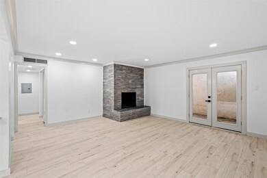 Unfurnished living room with ornamental molding, f