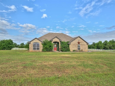 French provincial home featuring brick siding and roof with shingles